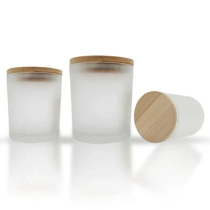 three glass jars with wooden lids on a white surface
